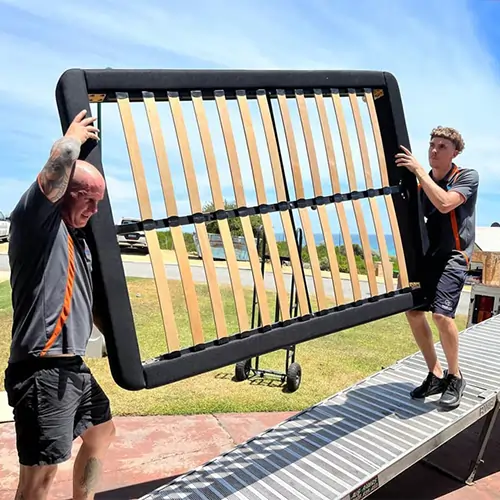 JK's Small Moves Perth Movers Carrying a Bed Frame onto the Truck